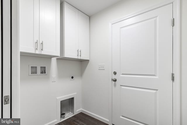 laundry room with dark wood-type flooring, hookup for a washing machine, electric dryer hookup, and cabinets