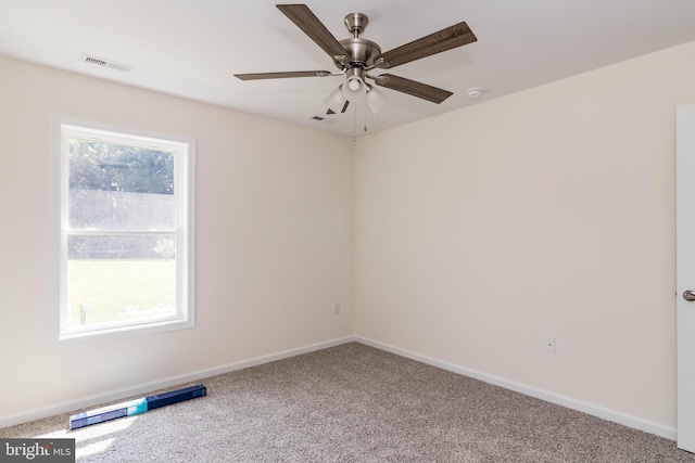 carpeted spare room with ceiling fan