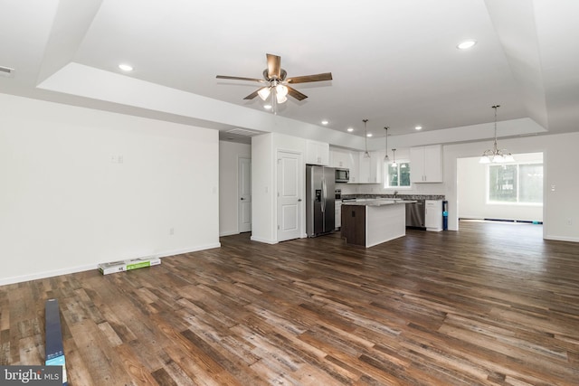 kitchen with white cabinetry, a center island, hanging light fixtures, and dark hardwood / wood-style floors