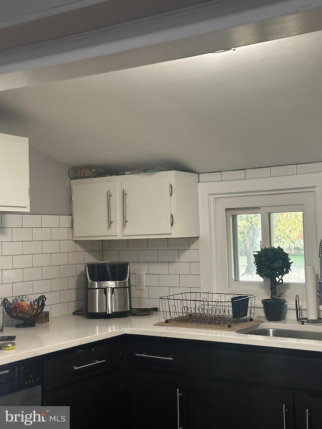 kitchen with white cabinetry, sink, and decorative backsplash