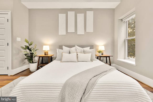 bedroom featuring hardwood / wood-style floors and multiple windows