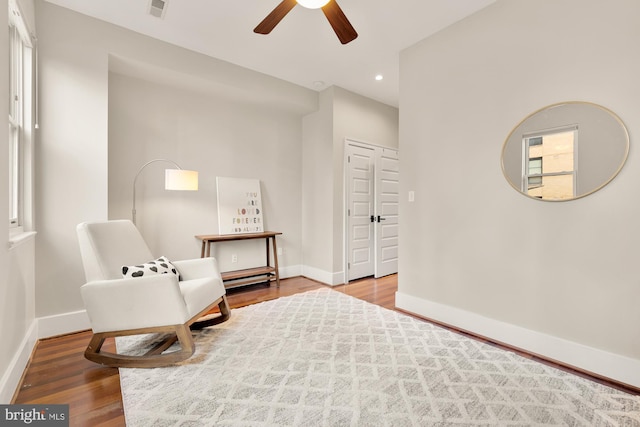 sitting room with ceiling fan, plenty of natural light, and hardwood / wood-style floors