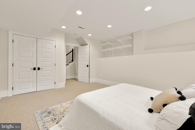 carpeted bedroom with a closet