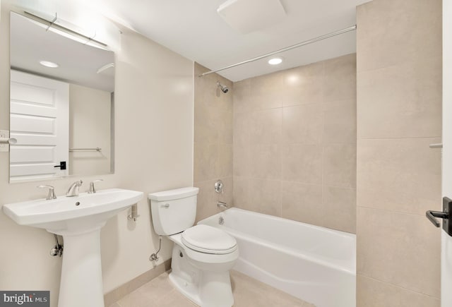 bathroom with tile patterned floors, tiled shower / bath combo, and toilet