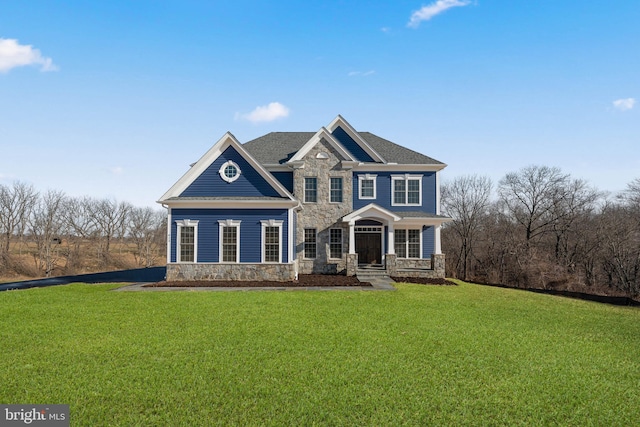 view of front of home with covered porch and a front lawn