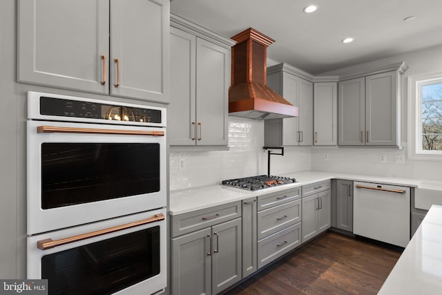 kitchen featuring white appliances, dark hardwood / wood-style floors, and gray cabinets