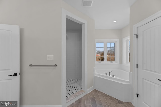 bathroom featuring shower with separate bathtub and hardwood / wood-style flooring