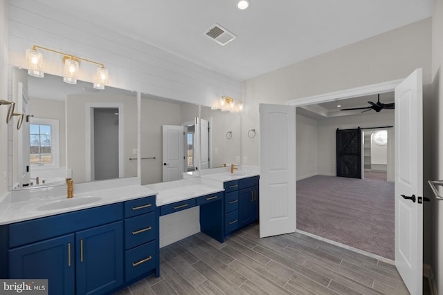 bathroom featuring vanity, hardwood / wood-style floors, and ceiling fan