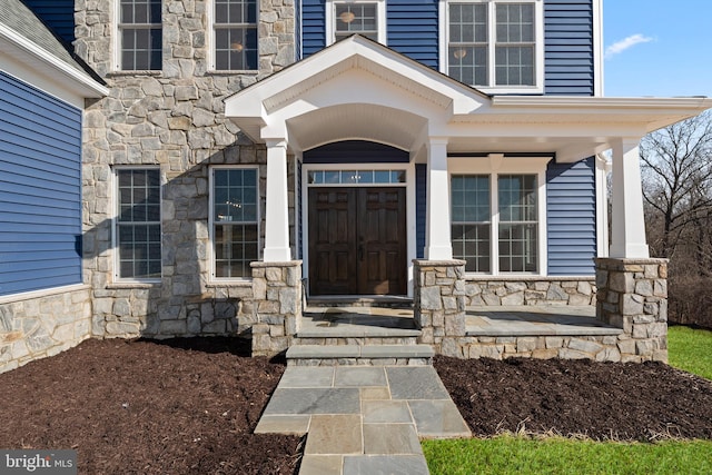 doorway to property featuring covered porch