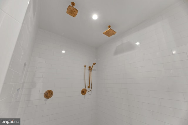 interior details with a tile shower