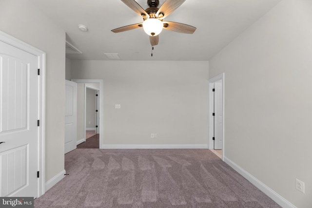 spare room featuring light carpet and ceiling fan