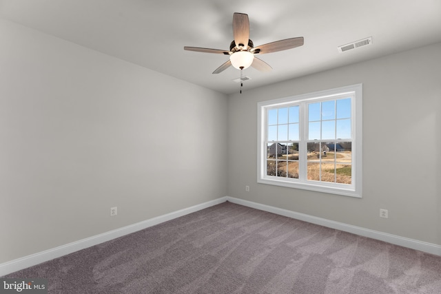 carpeted spare room with ceiling fan