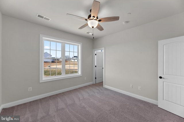 empty room featuring light colored carpet and ceiling fan