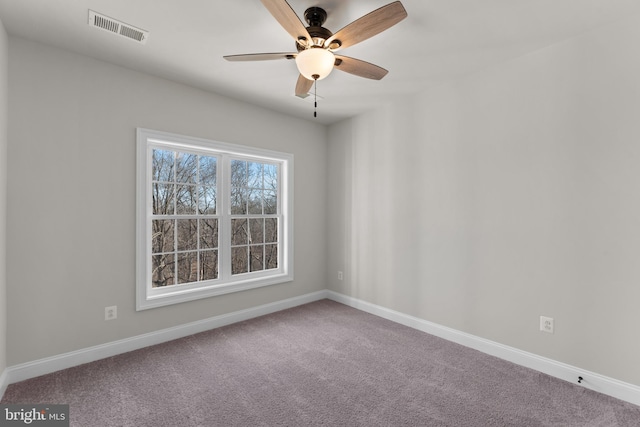 carpeted spare room with ceiling fan