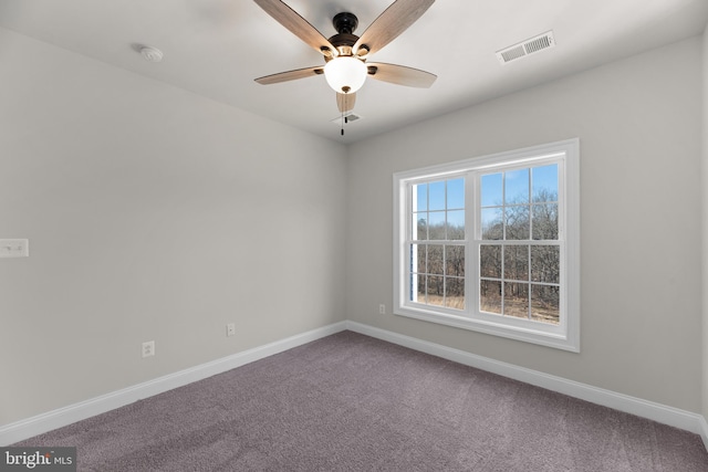 spare room featuring ceiling fan and carpet floors