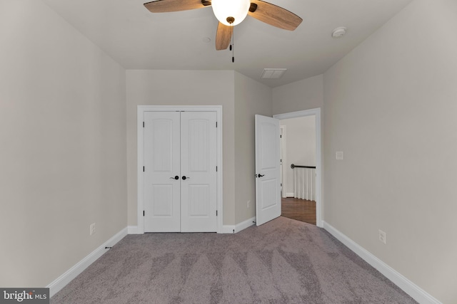 unfurnished bedroom featuring light carpet, a closet, and ceiling fan