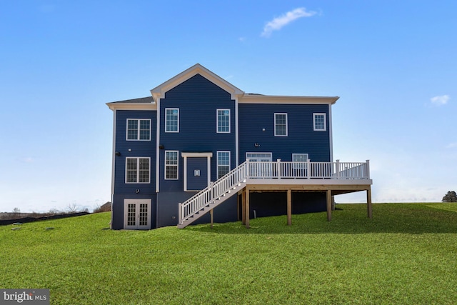 rear view of property featuring a yard and a deck