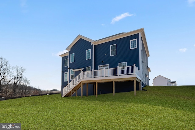 back of house with a deck and a lawn