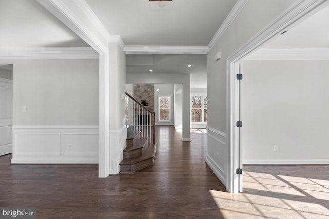 foyer featuring dark wood-type flooring and crown molding