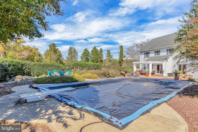 view of swimming pool with a pergola