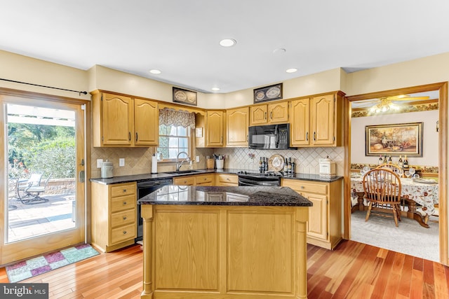 kitchen featuring black appliances, light hardwood / wood-style floors, and a healthy amount of sunlight