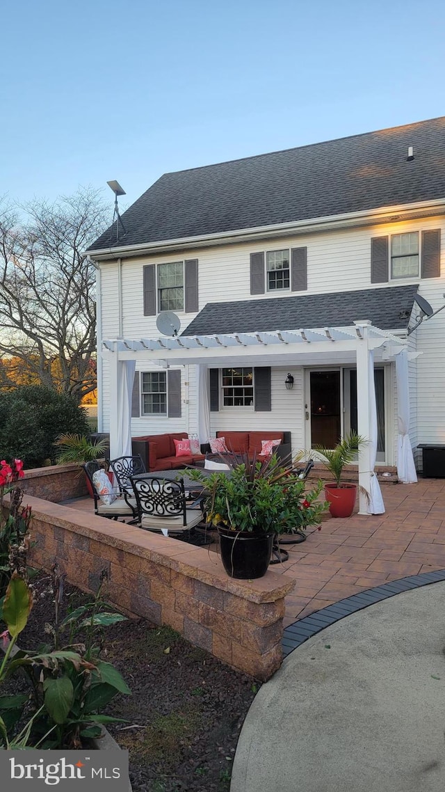 rear view of house featuring outdoor lounge area, a patio, and a pergola