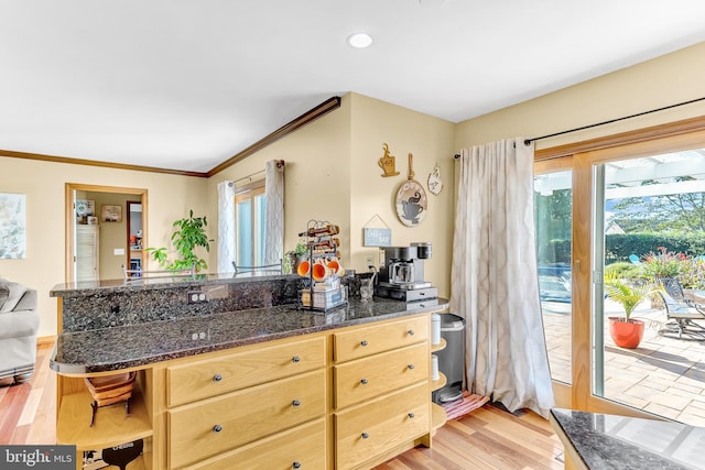 kitchen with light hardwood / wood-style floors, crown molding, and light brown cabinetry