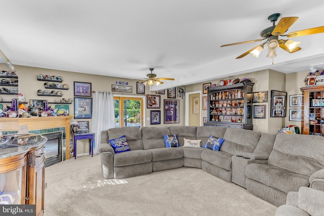 carpeted living room with ceiling fan