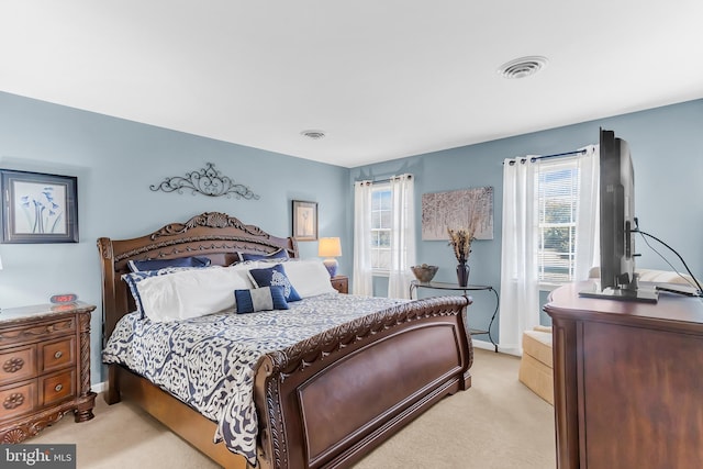 bedroom featuring light colored carpet