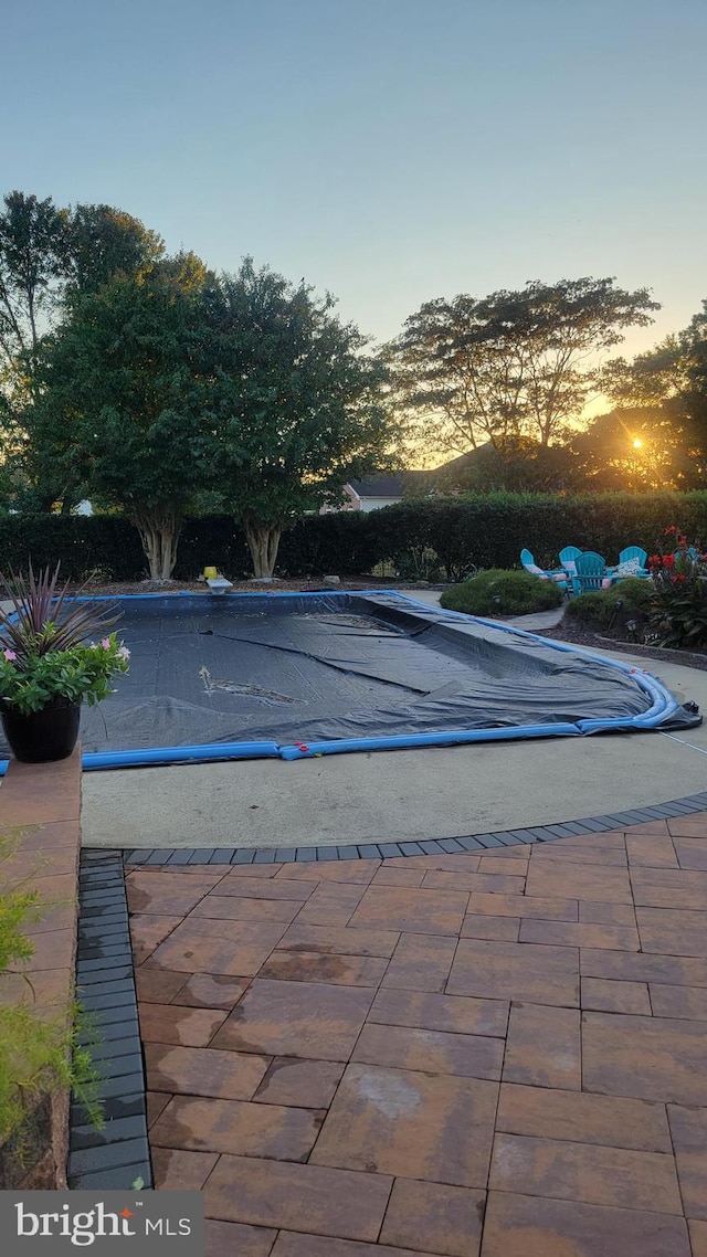 view of pool at dusk