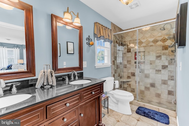 bathroom featuring vanity, an enclosed shower, toilet, and tile patterned flooring