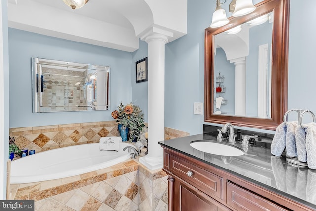 bathroom with vanity, separate shower and tub, and ornate columns