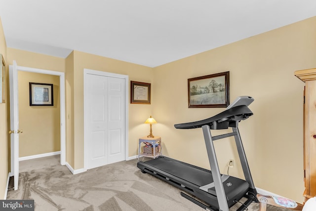 exercise area featuring light colored carpet