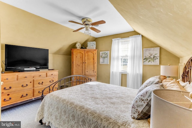 carpeted bedroom featuring lofted ceiling and ceiling fan