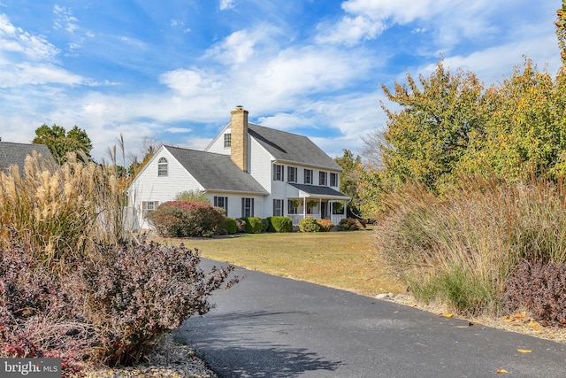 view of property exterior featuring a yard and a porch