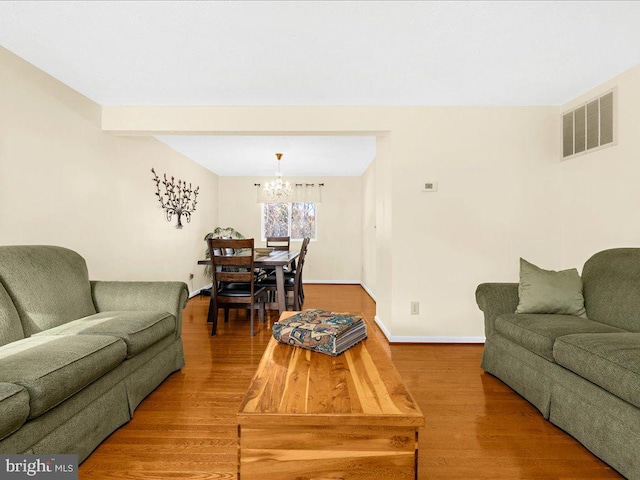 living room with a chandelier and wood-type flooring