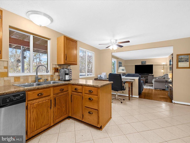 kitchen with sink, stainless steel dishwasher, ceiling fan, tasteful backsplash, and light tile patterned flooring