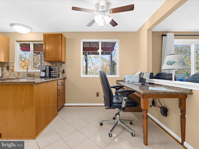 office area with light tile patterned floors and ceiling fan