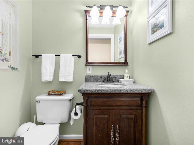 bathroom featuring hardwood / wood-style floors, vanity, and toilet