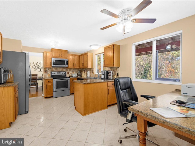 office with ceiling fan, sink, and light tile patterned flooring