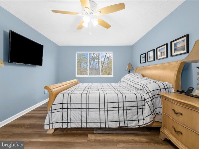 bedroom with ceiling fan and dark wood-type flooring