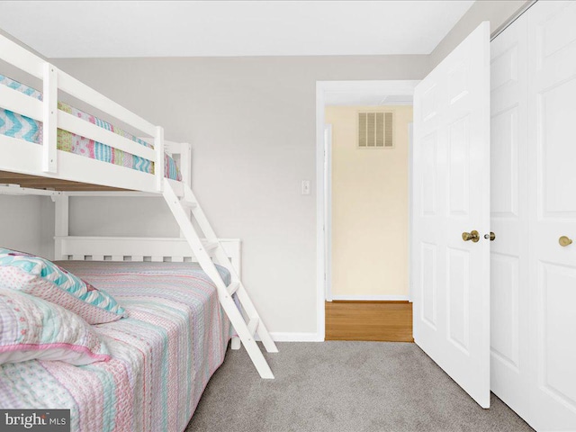 carpeted bedroom featuring a closet