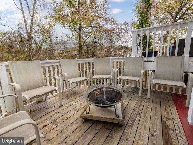 wooden terrace with an outdoor fire pit