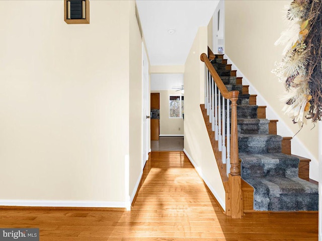 stairs featuring hardwood / wood-style flooring