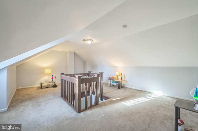 additional living space featuring light carpet and lofted ceiling