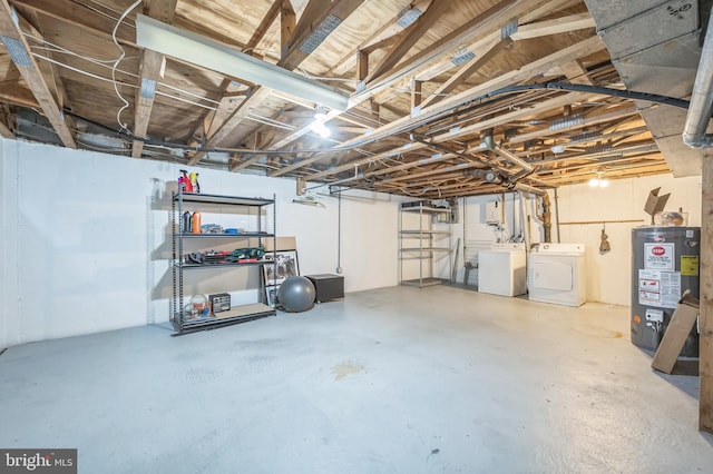 basement featuring water heater and washing machine and clothes dryer