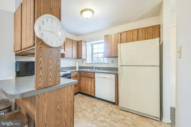 kitchen featuring white appliances and sink