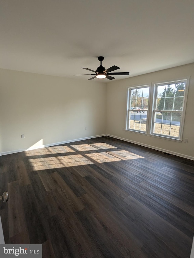 empty room featuring ceiling fan and dark hardwood / wood-style floors