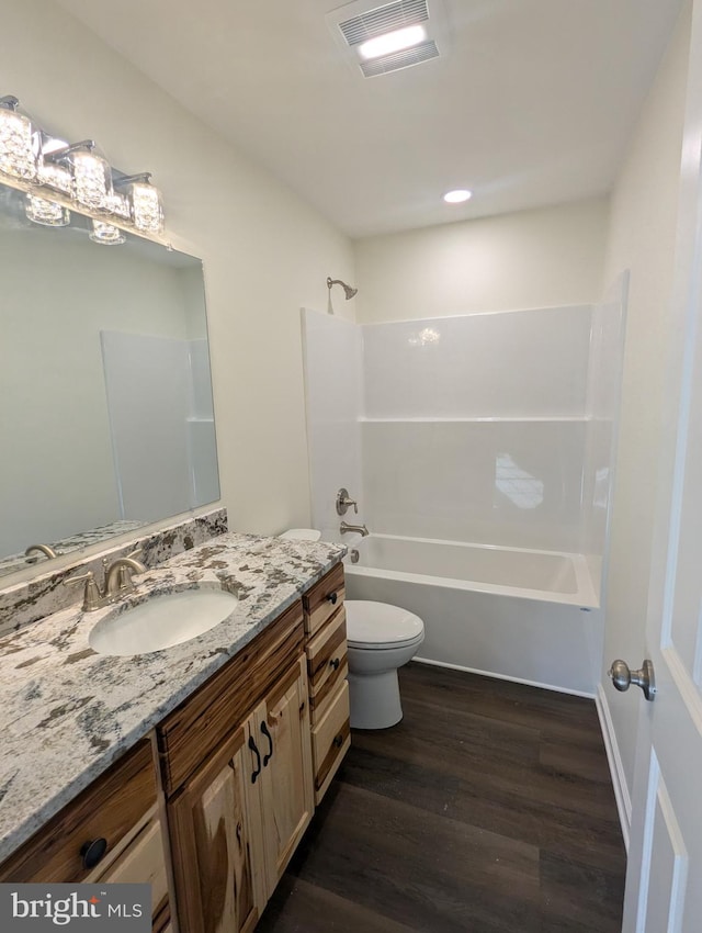 full bathroom featuring vanity, shower / tub combination, toilet, and wood-type flooring