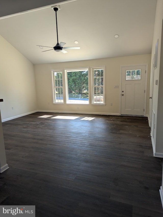 unfurnished living room featuring dark wood-type flooring, ceiling fan, and vaulted ceiling